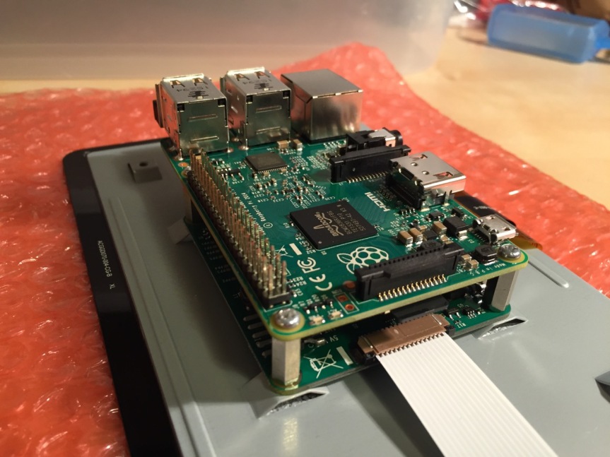 Place the Raspberry Pi above the display controller card and attach with the supplied screws that screw into the top of the standoff posts.