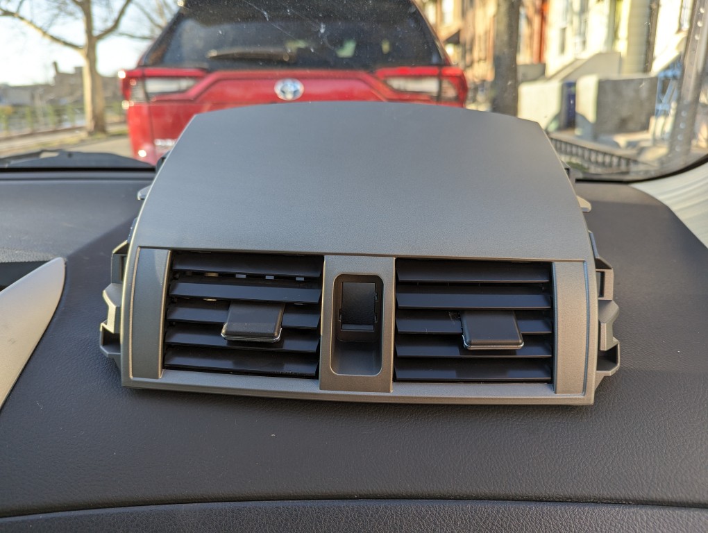 Replacement 2013 Toyota Corolla center console air vent assembly.