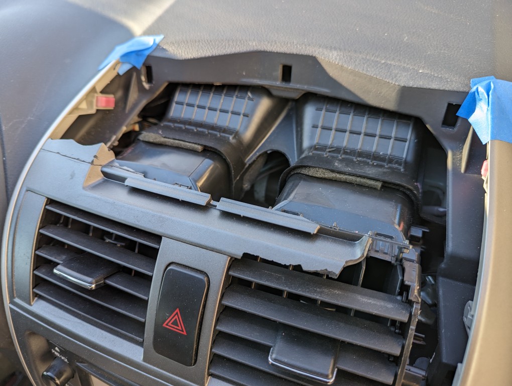 Broken 2013 Toyota Corolla center console air vent component.