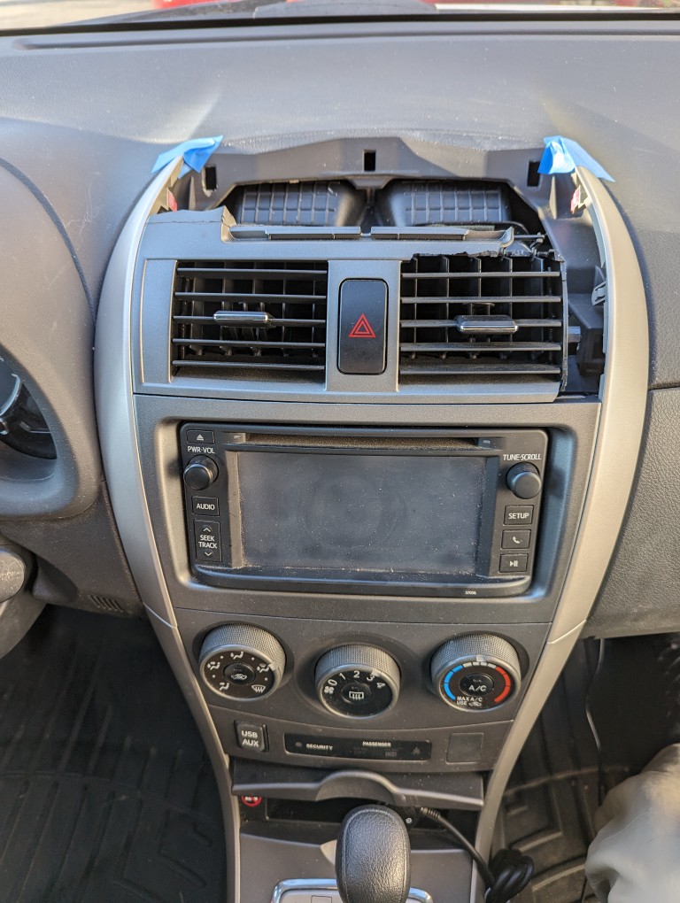 Broken 2013 Toyota Corolla center console air vent component.
