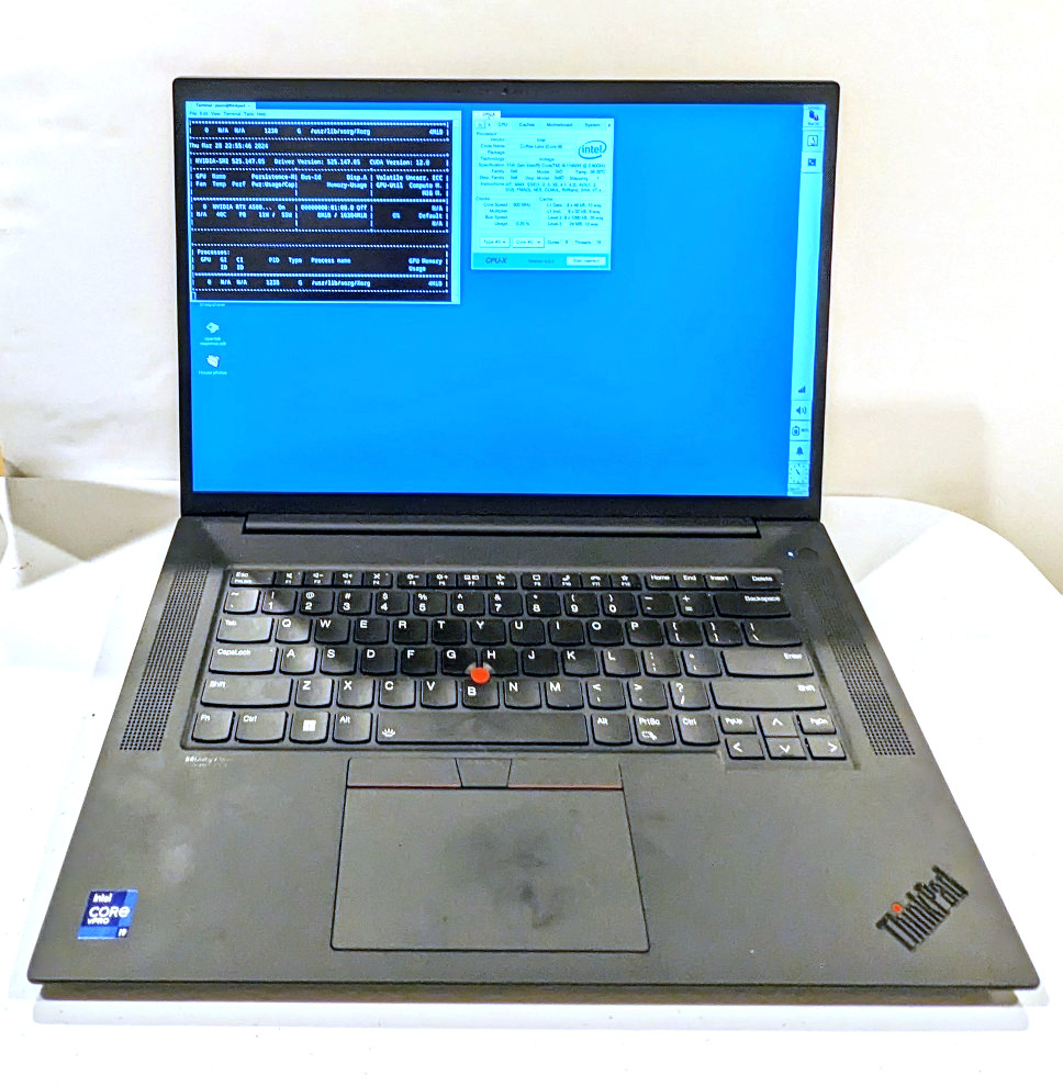Lenovo ThinkPad P1 Gen 4 16" QHD+ i9-11950H✓64GB RAM✓2TB SSD✓RTX A5000 with screen open and showing Debian 12 desktop